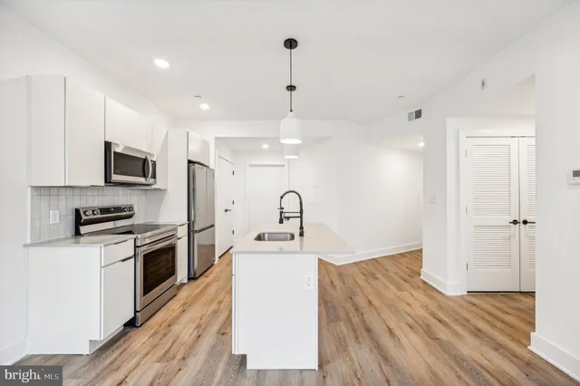 a view of kitchen with wooden floor