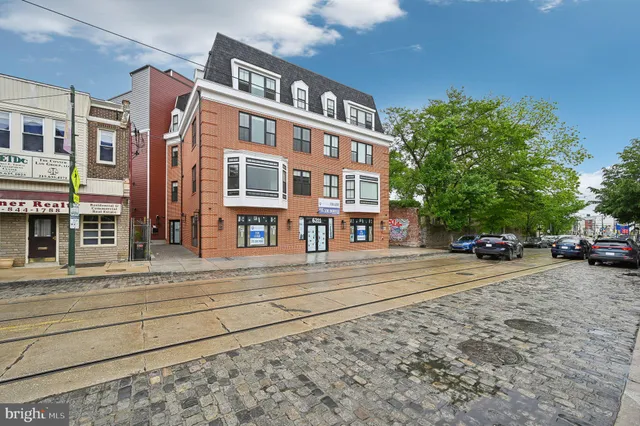 a view of a brick building next to a road