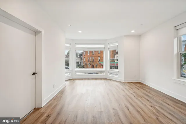 a view of kitchen with wooden floor and electronic appliances