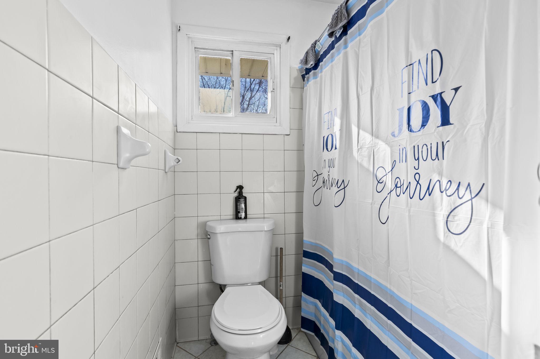 3407 Orbitan Road Parkville, MD 21234 - Photo 20 of 23 a white toilet sitting next to a bathroom sink