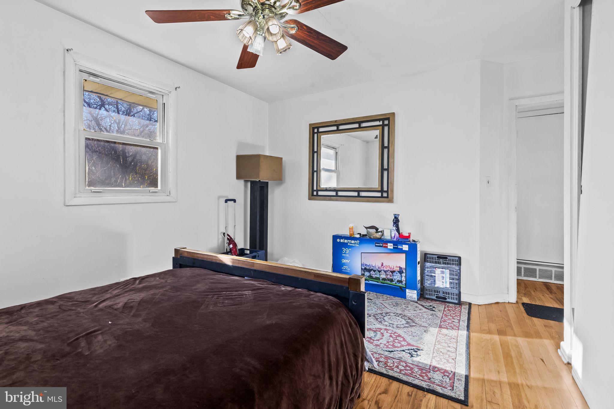 3407 Orbitan Road Parkville, MD 21234 - Photo 9 of 23 a bedroom with furniture and a chandelier