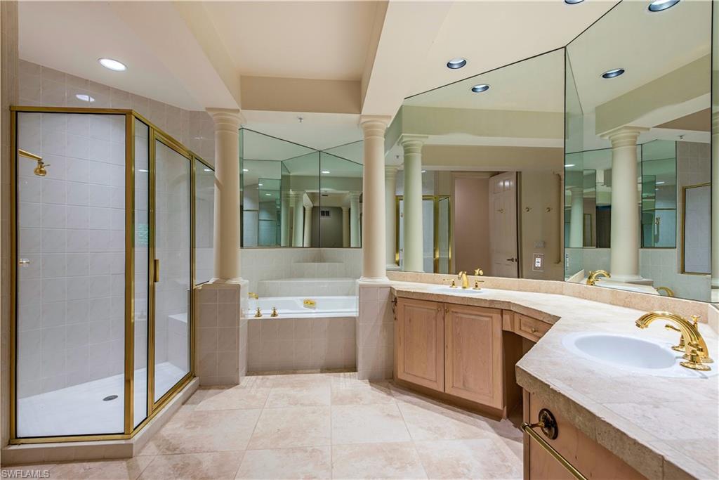 157 Colonade Circle, Unit 1002 Naples, FL 34103 - Photo 12 of 23 Bathroom featuring independent shower and bath, tile patterned flooring, vanity, and ornate columns