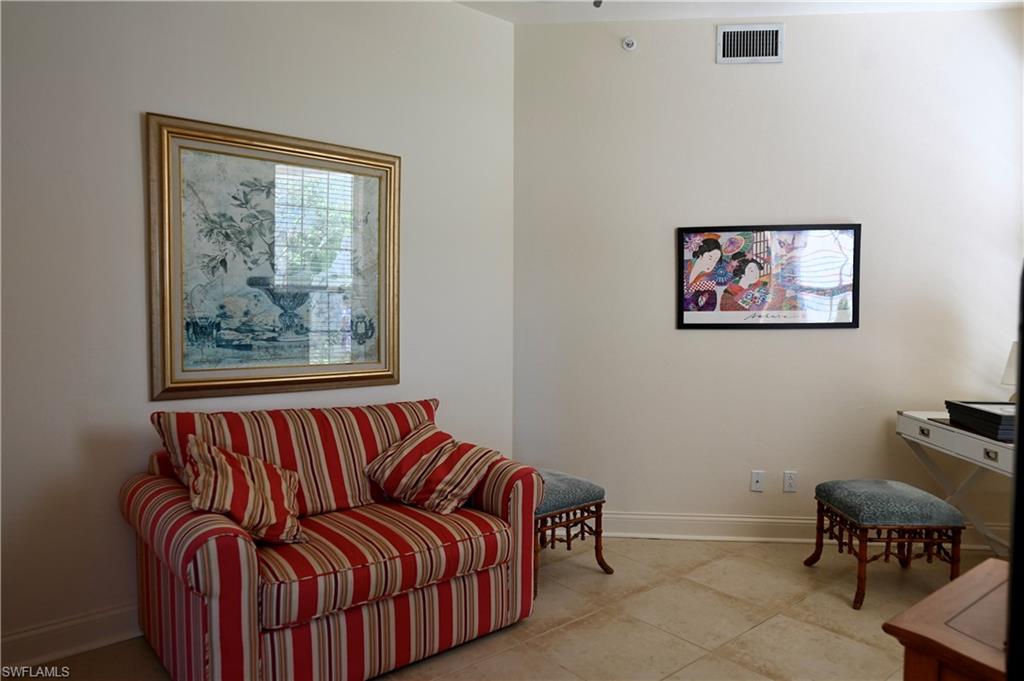 157 Colonade Circle, Unit 1002 Naples, FL 34103 - Photo 17 of 23 Living room with light tile patterned flooring