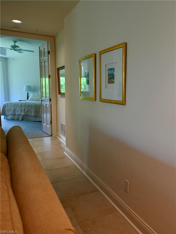 157 Colonade Circle, Unit 1002 Naples, FL 34103 - Photo 18 of 23 Hallway featuring light tile patterned floors