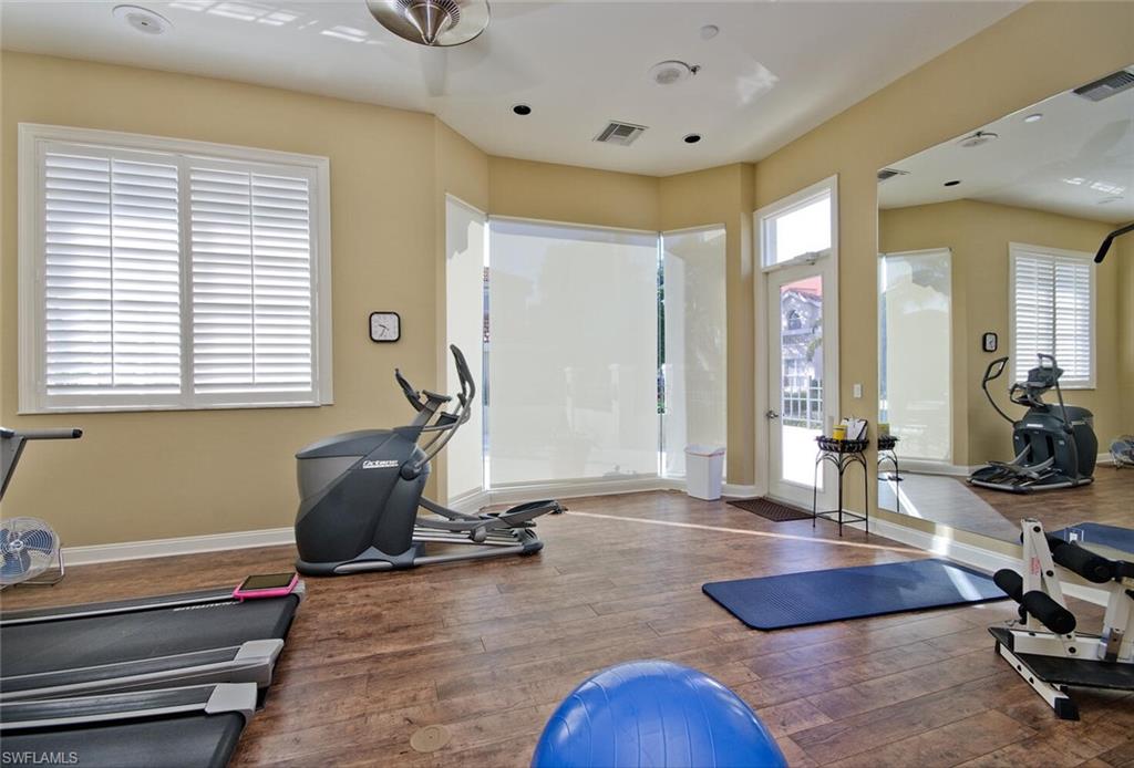 157 Colonade Circle, Unit 1002 Naples, FL 34103 - Photo 23 of 23 Exercise room with a healthy amount of sunlight and hardwood / wood-style floors