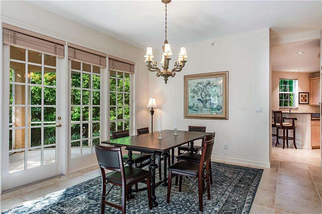 157 Colonade Circle, Unit 1002 Naples, FL 34103 - Photo 7 of 23 Tiled dining room featuring a notable chandelier and sink