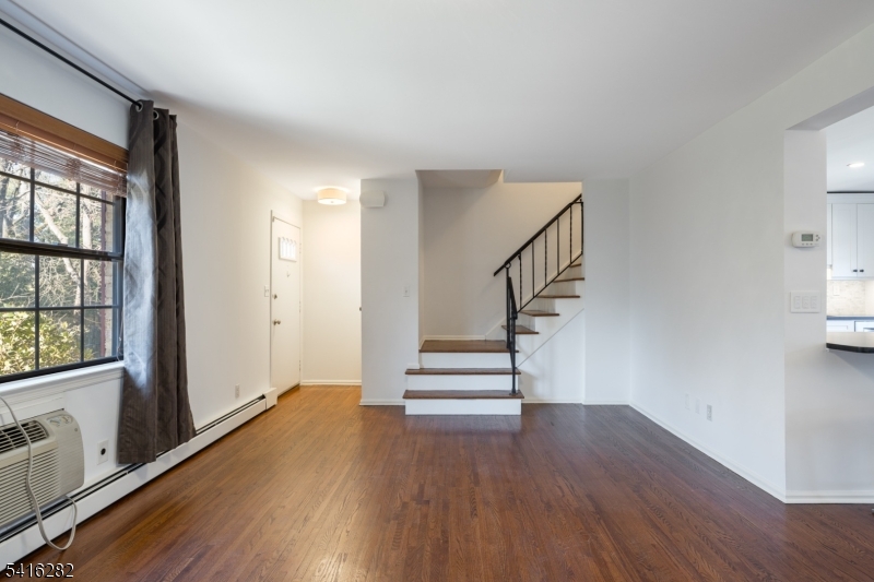 768 Springfield Avenue, Unit E4 Summit, NJ 07901 - Photo 14 of 28 a view of entryway with wooden floor and stairs