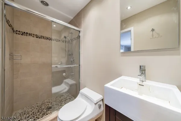 a bathroom with a sink toilet and shower