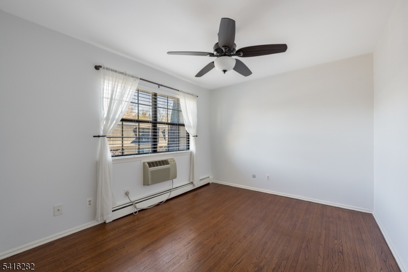 768 Springfield Avenue, Unit E4 Summit, NJ 07901 - Photo 19 of 28 wooden floor in an empty room with a window