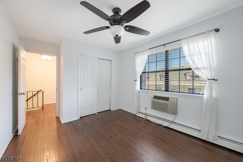 768 Springfield Avenue, Unit E4 Summit, NJ 07901 - Photo 20 of 28 a view of an empty room with window and wooden floor
