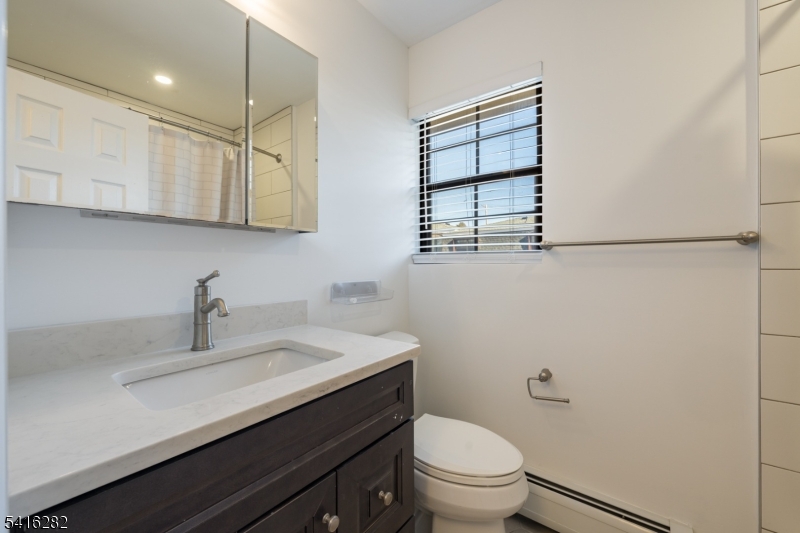 768 Springfield Avenue, Unit E4 Summit, NJ 07901 - Photo 21 of 28 a bathroom with a sink a toilet and shower