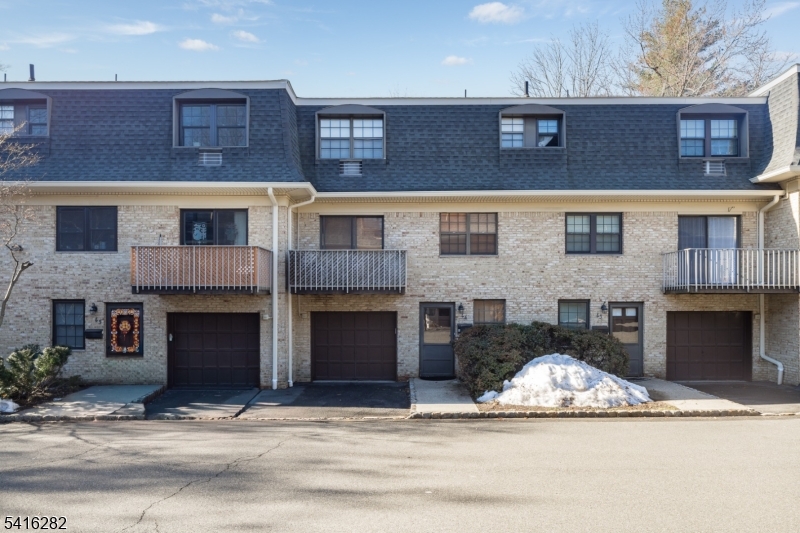 768 Springfield Avenue, Unit E4 Summit, NJ 07901 - Photo 25 of 28 a front view of a house with a yard and garage