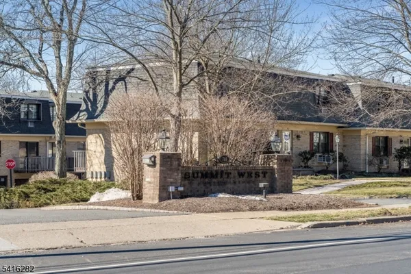 a view of a house with a yard covered in snow