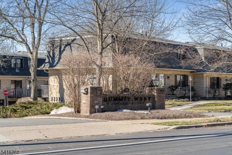 768 Springfield Avenue, Unit E4 Summit, NJ 07901 - Photo 28 of 28 a view of a house with a yard covered in snow