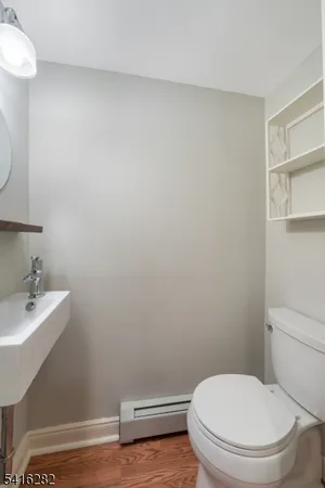 a white toilet sitting next to a bathroom sink