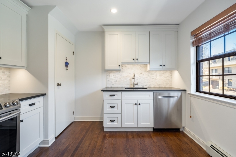 768 Springfield Avenue, Unit E4 Summit, NJ 07901 - Photo 5 of 28 a kitchen with granite countertop white cabinets and white appliances