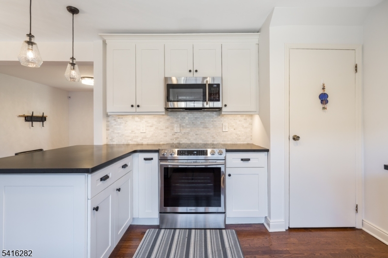 768 Springfield Avenue, Unit E4 Summit, NJ 07901 - Photo 7 of 28 a kitchen with stainless steel appliances granite countertop a stove and a refrigerator
