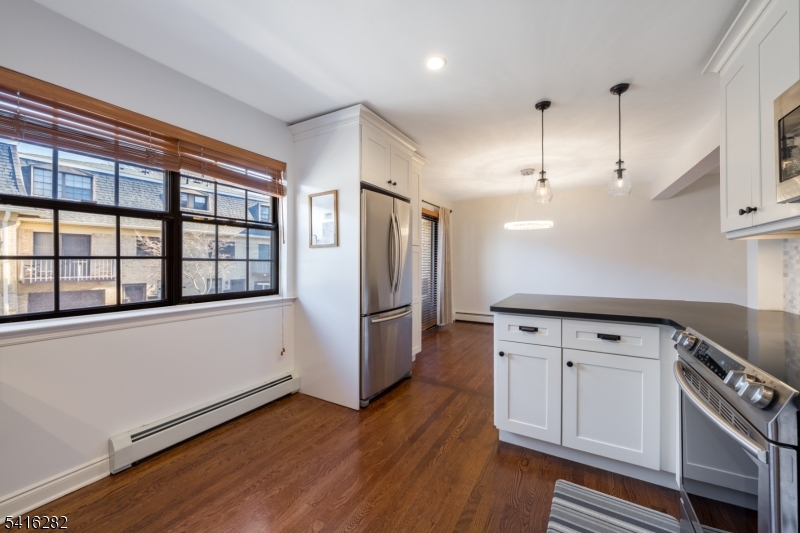 768 Springfield Avenue, Unit E4 Summit, NJ 07901 - Photo 8 of 28 a kitchen with granite countertop white cabinets and white appliances