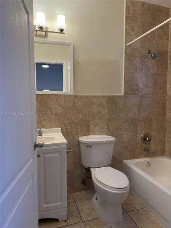 a bathroom with a toilet a sink and bathtub