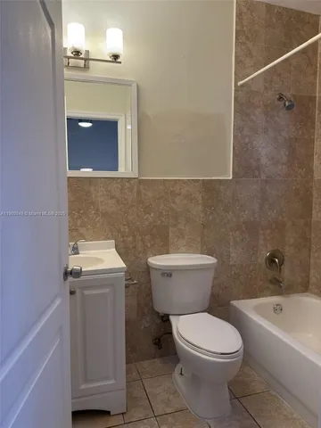 a bathroom with a toilet a sink and bathtub