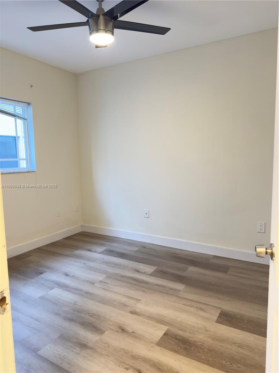 1930 Southwest 2nd Street, Unit 3 Miami, FL 33135 - Photo 4 of 6 an empty room with wooden floor and windows
