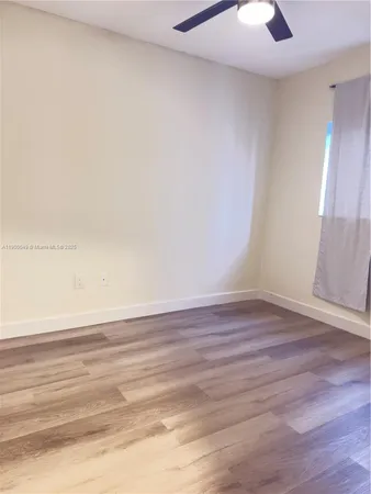 a view of an empty room and wooden floor