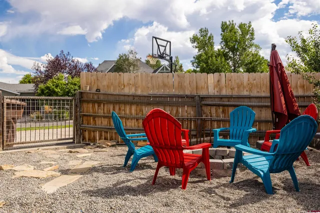 a backyard view with a seating space