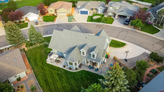 an aerial view of a house with outdoor space pool seating area and yard