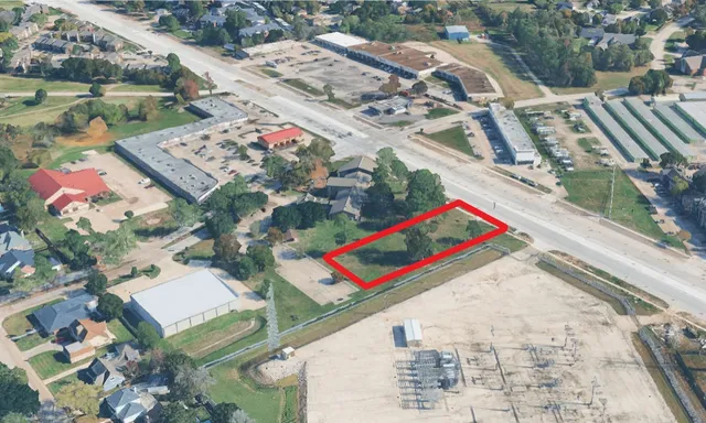 a view of a big yard with lots of bushes