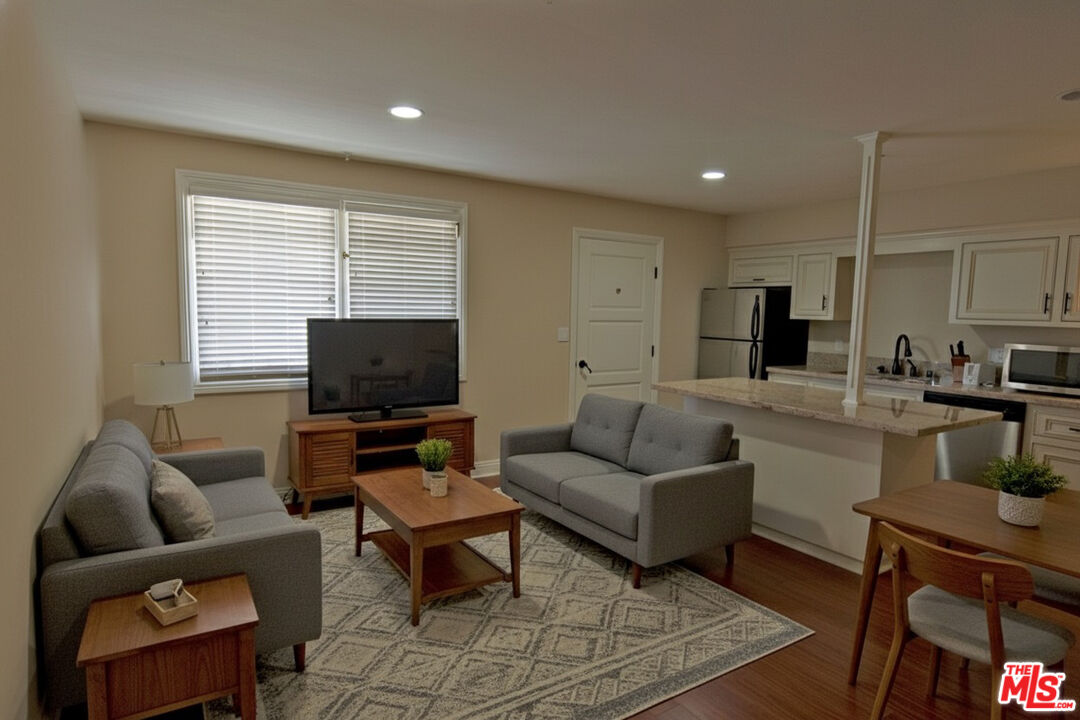 2646 Ellendale Place, Unit 2646 Los Angeles, CA 90007 - Photo 2 of 6 a living room with furniture and a flat screen tv