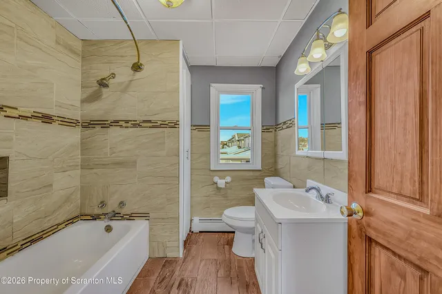 a bathroom with a tub a sink and a shower