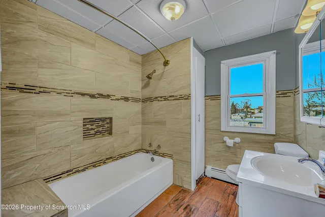a view of a room with wooden floor and window
