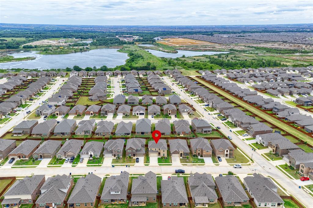 3808 High Country Road Aubrey, TX 76227 - Photo 31 of 36 Aerial view of a residential neighborhood with uniform rooflines and a visible street grid