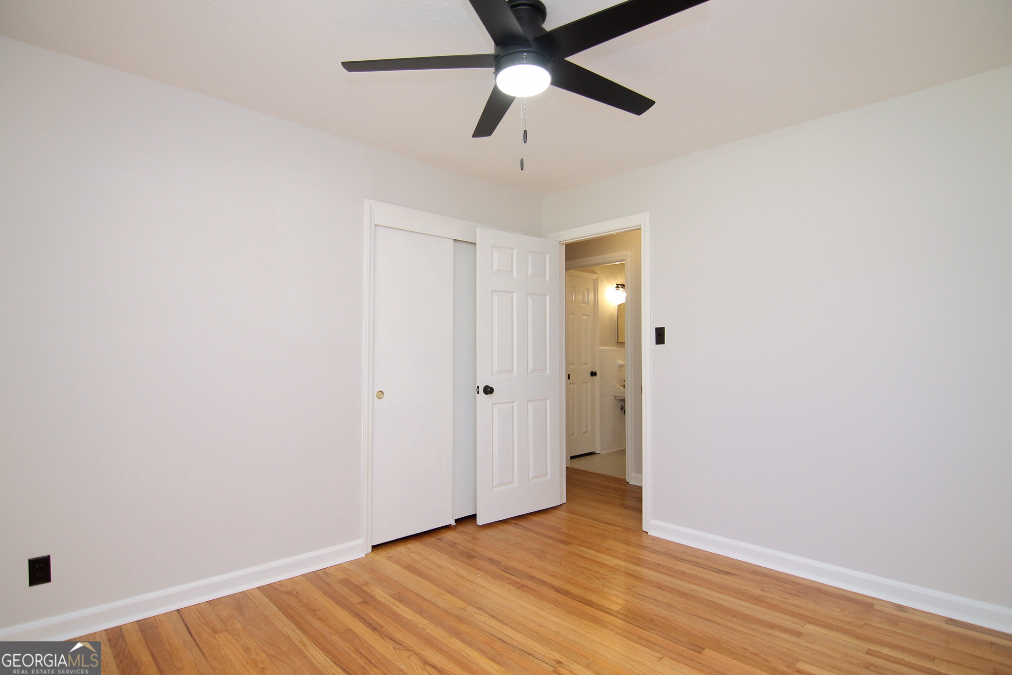110 Springdale Drive Warner Robins, GA 31088 - Photo 13 of 25 a view of an empty room with wooden floor