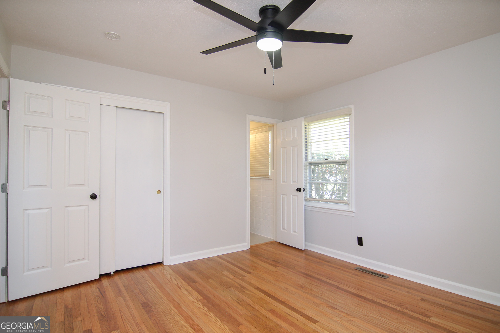 110 Springdale Drive Warner Robins, GA 31088 - Photo 15 of 25 a view of empty room with wooden floor and fan