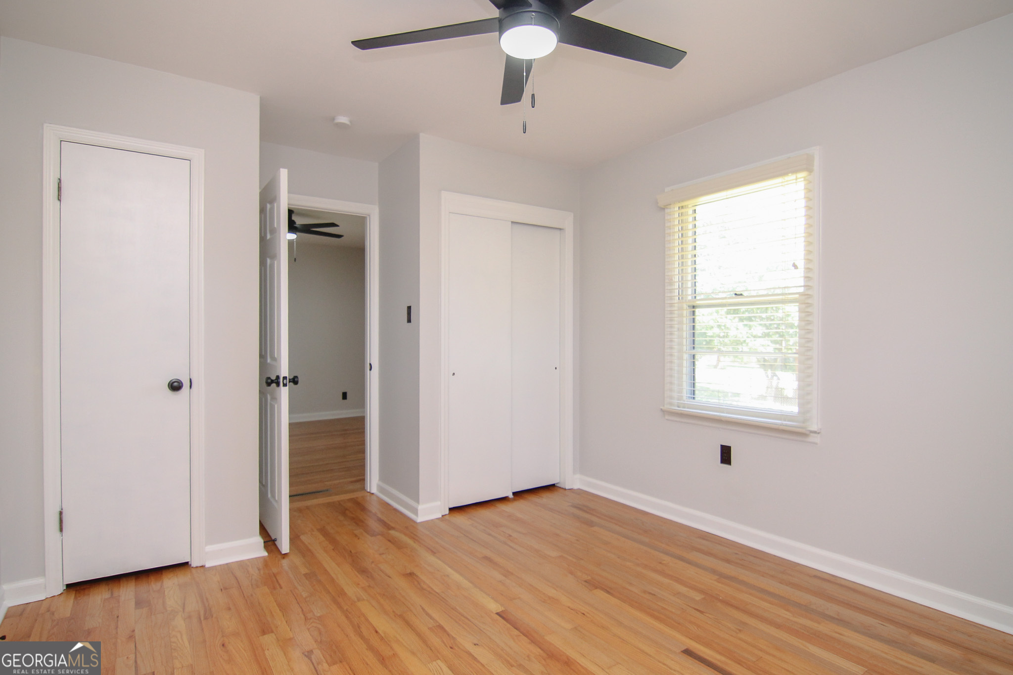 110 Springdale Drive Warner Robins, GA 31088 - Photo 20 of 25 a view of an empty room with wooden floor and a window