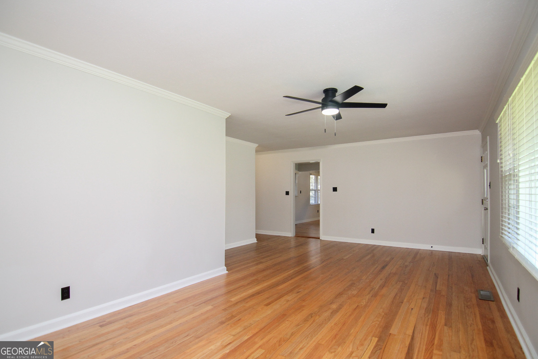 110 Springdale Drive Warner Robins, GA 31088 - Photo 4 of 25 a view of a room with wooden floor and a ceiling fan