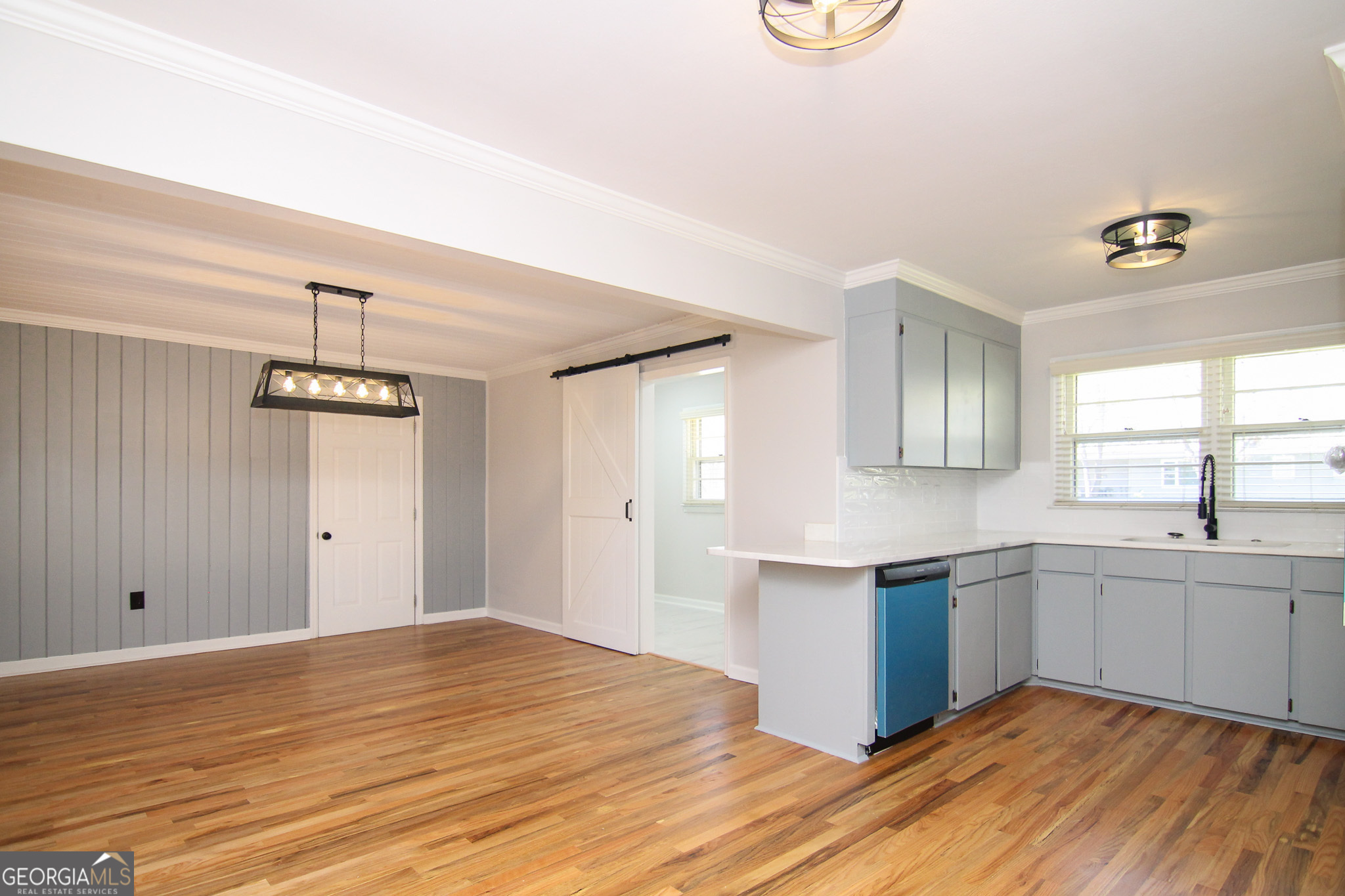 110 Springdale Drive Warner Robins, GA 31088 - Photo 5 of 25 a kitchen with stainless steel appliances granite countertop a sink and dishwasher with wooden floor
