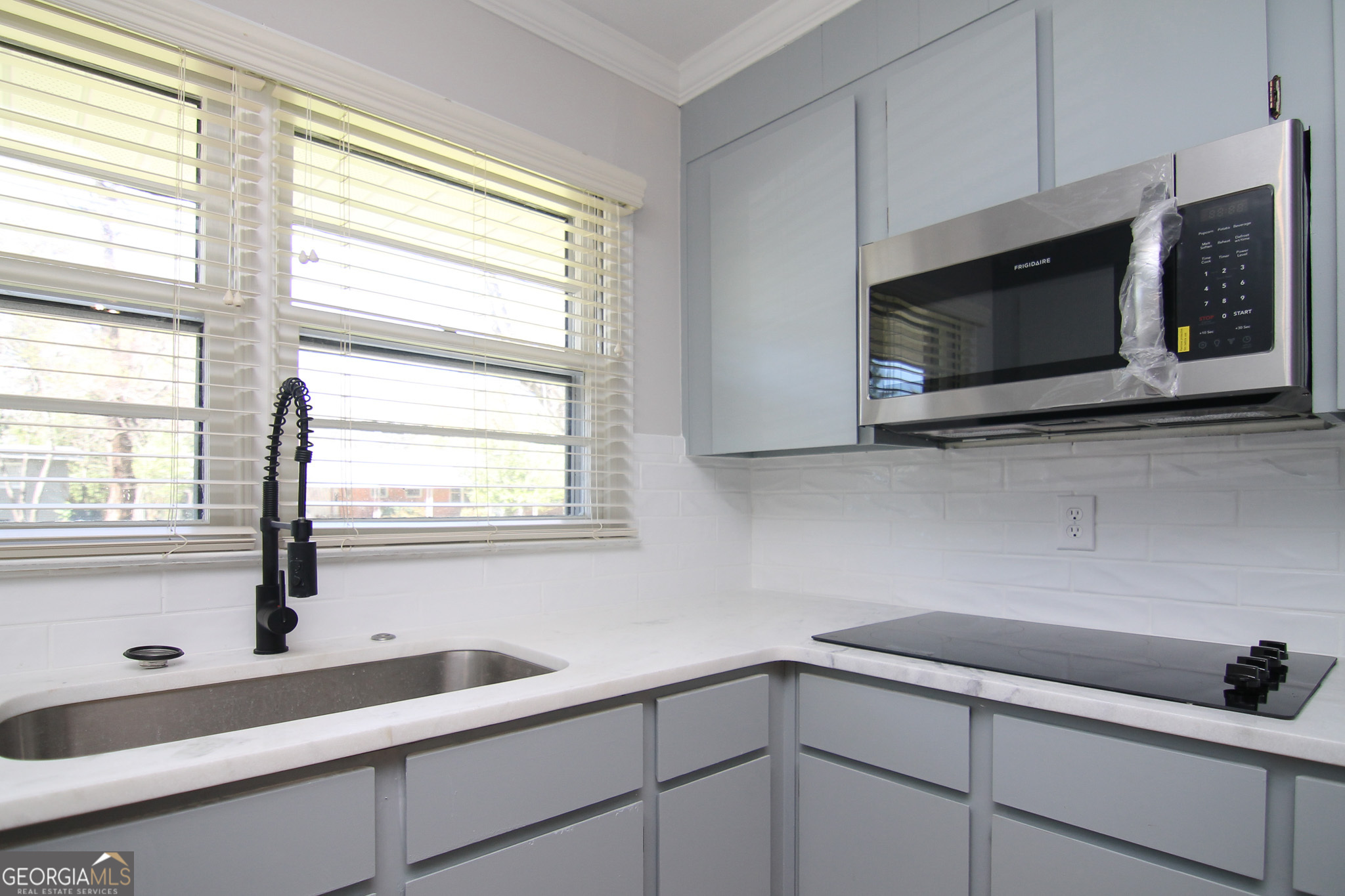 110 Springdale Drive Warner Robins, GA 31088 - Photo 7 of 25 a kitchen with stainless steel appliances a sink a stove and microwave