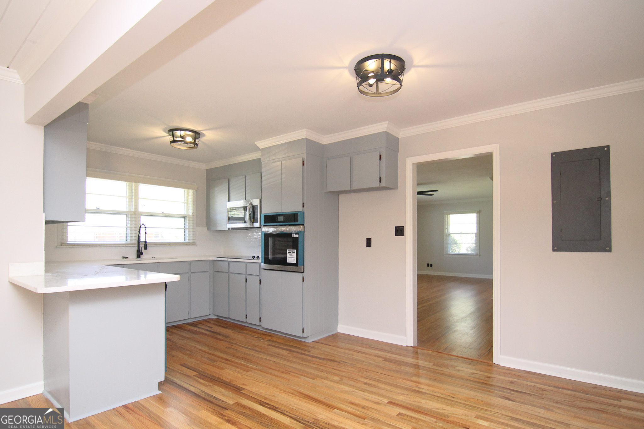 110 Springdale Drive Warner Robins, GA 31088 - Photo 8 of 25 a kitchen with cabinets and wooden floor