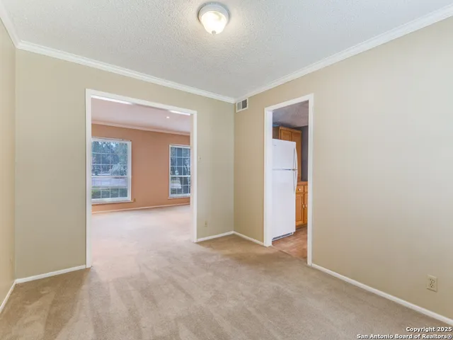 an empty room with closet and mirrors