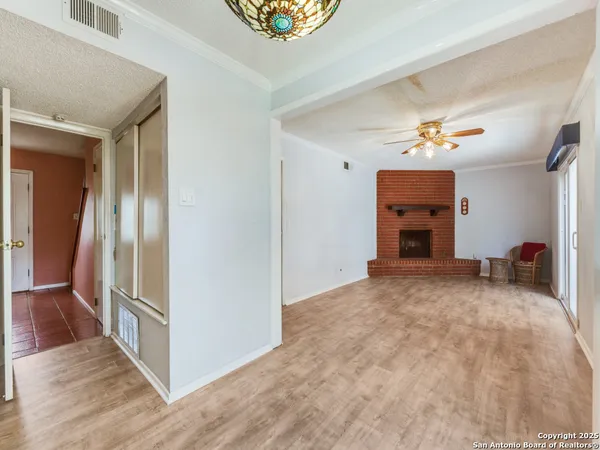 a view of empty room with a fireplace and cabinet