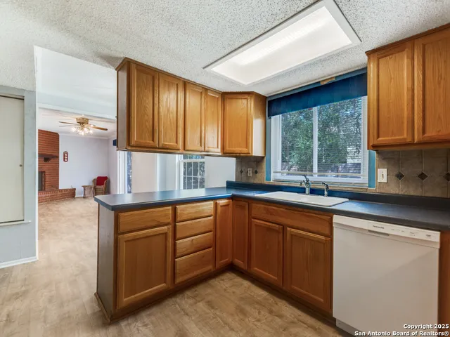 a kitchen with sink cabinets and window