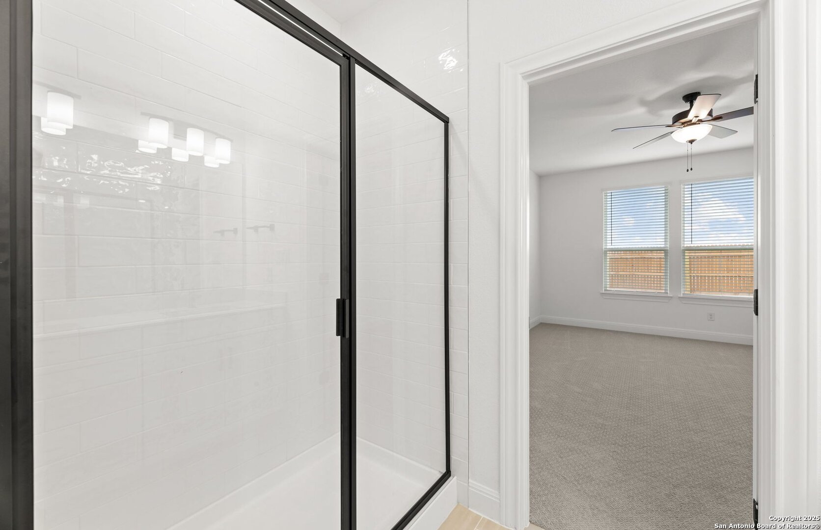 419 Nightingale Avenue Marion, TX 78124 - Photo 17 of 32 a bathroom with a glass shower door and a mirror
