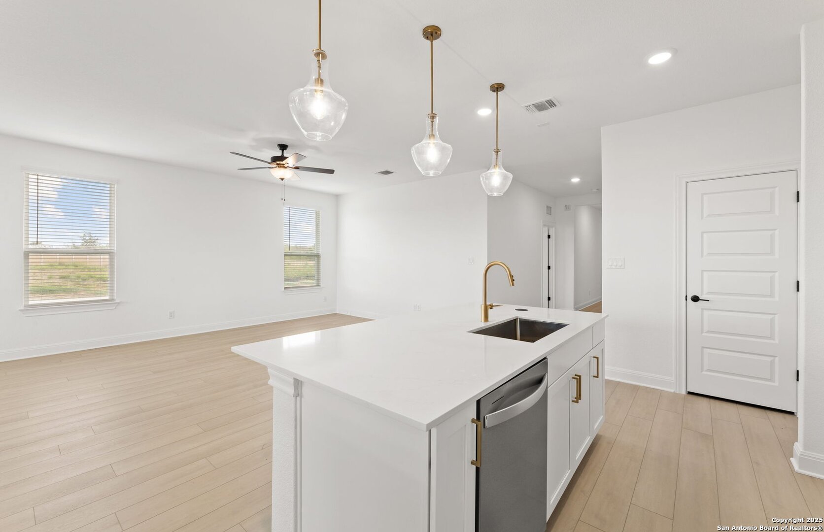 419 Nightingale Avenue Marion, TX 78124 - Photo 9 of 32 a kitchen that has a sink a stove and a wooden floor