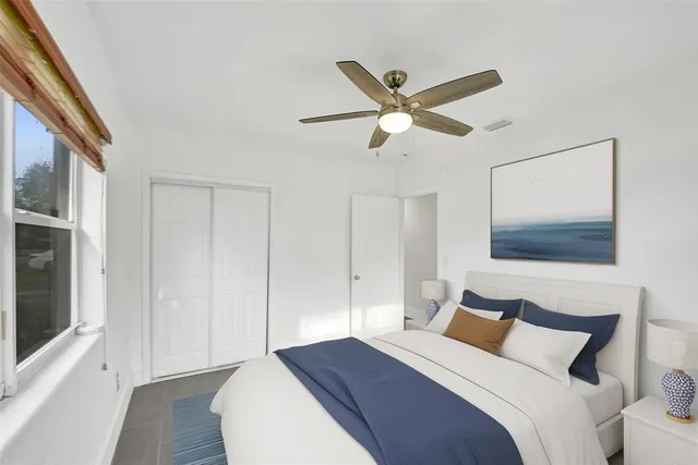 a bedroom with a bed and a painting on the wall