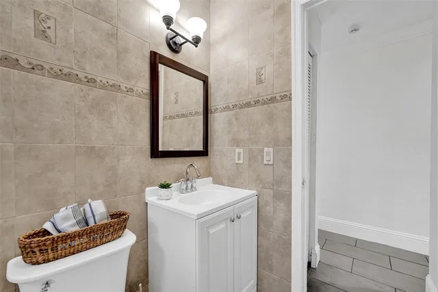 a bathroom with a sink toilet and vanity