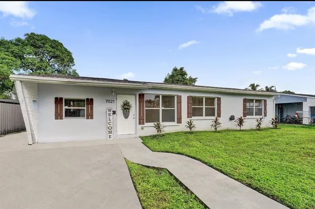 a front view of a house with a garden and porch
