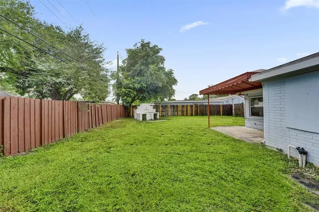 a view of a house with backyard and porch