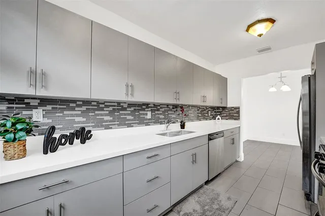 a kitchen with a sink and cabinets